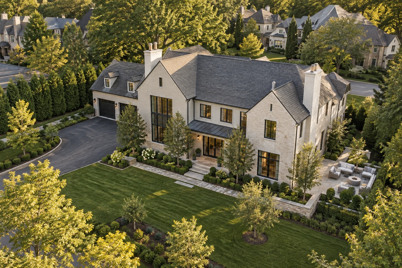 An elevated aerial view showing a home, its grounds and surrounding landscape
